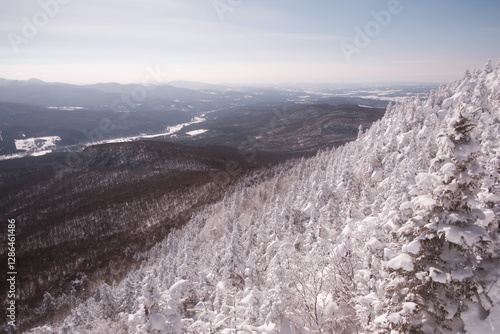 view from the top of a snow-covered mountain, of landscapes, mountains and rivers in the distance