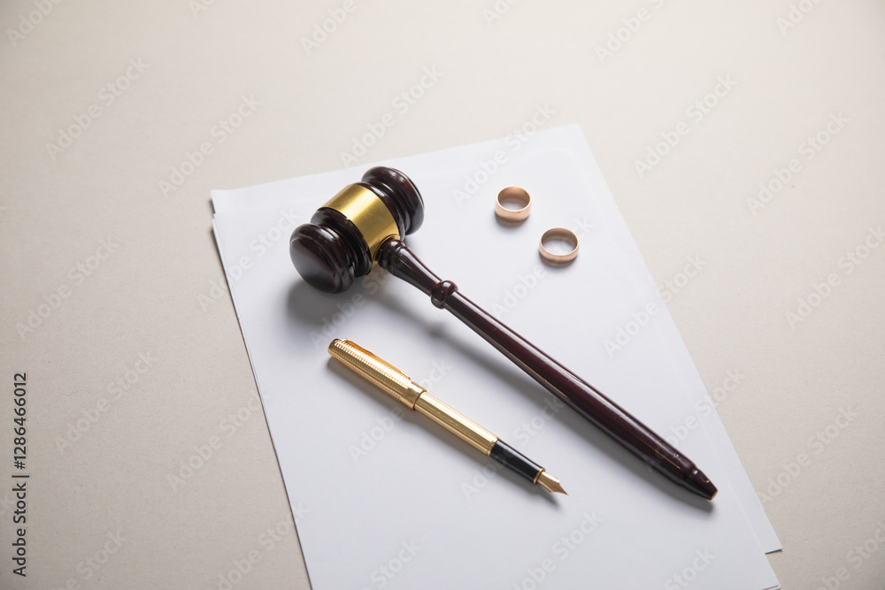 Fototapeta premium Judge gavel, documents and wedding rings. Divorce