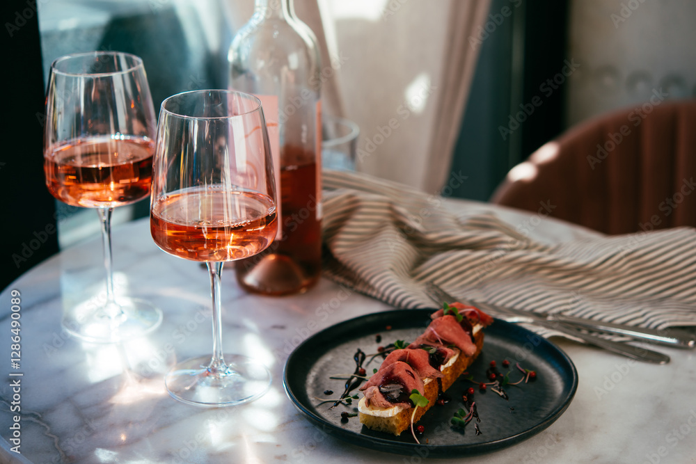 Glasses of rose wine seen during a friendly party or a celebration in a restaurant of a bar.
