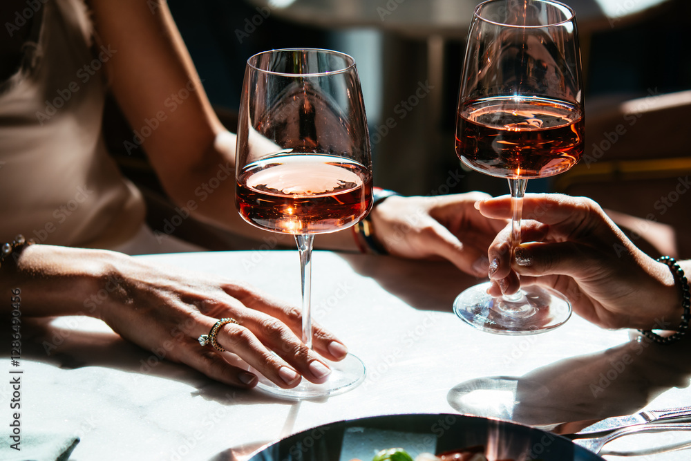 Glasses of rose wine seen during a friendly party or a celebration in a restaurant of a bar.