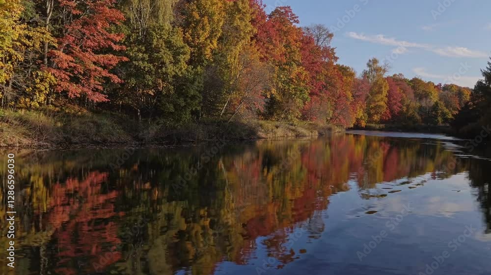 Autumn River Reflections: A serene river reflects the vibrant hues of autumn foliage, painting a mesmerizing tapestry of reds, oranges, and yellows against the backdrop of a clear blue sky. Autumn River Reflections: A serene river reflects the vibrant hues of autumn foliage, painting a mesmerizing tapestry of reds, oranges, and yellows against the backdrop of a clear blue sky.