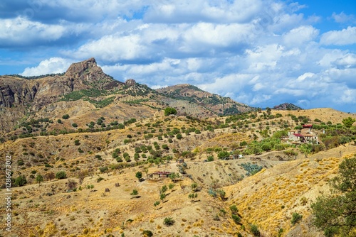 Olive groves and mountains around Ghost Town, Pentedattilo Village, Calabria, Italy, Europe photo