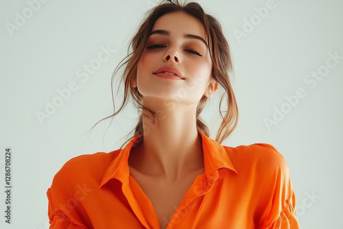 Young Woman With Curly Hair and Glasses Wears Orange Patterned Shirt Against ...
