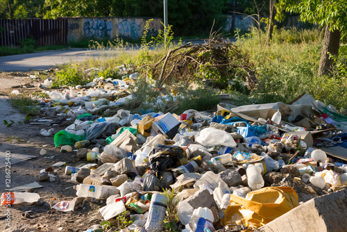 Large pile of litter and plastic waste polluting nature in urban area photo