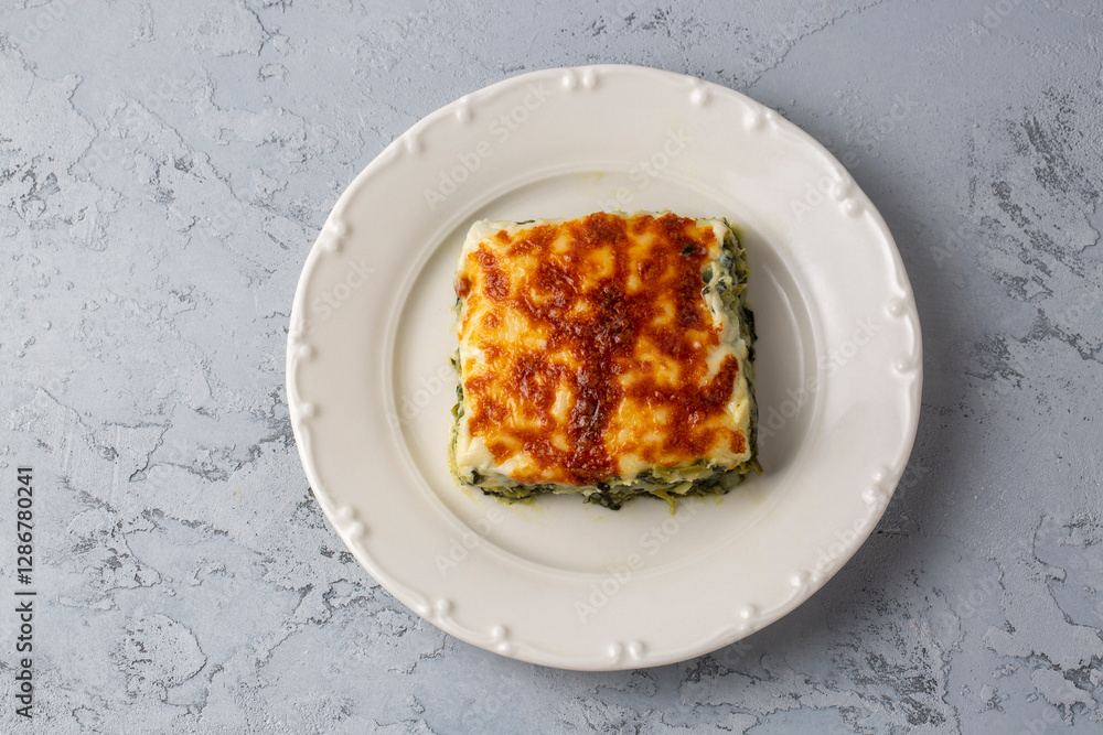 Baked Spinach with cheese delicious Italian food cuisine. Spinach gratin.
