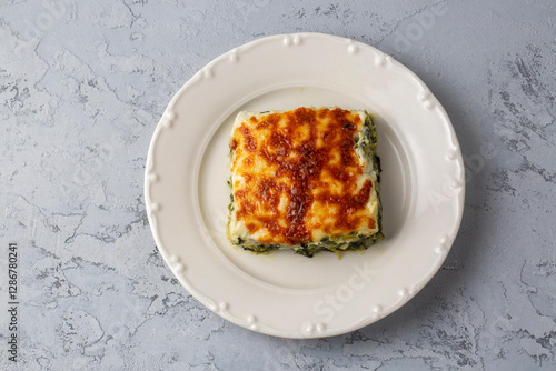 Baked Spinach with cheese delicious Italian food cuisine. Spinach gratin.