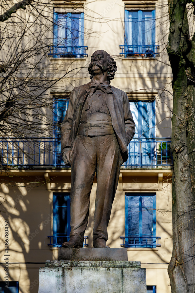 Naklejka premium ROUEN, NORMANDY, FRANCE - 2025: bronze statue of Gustave Flaubert, 19th century famous French writer, on Carmes Square