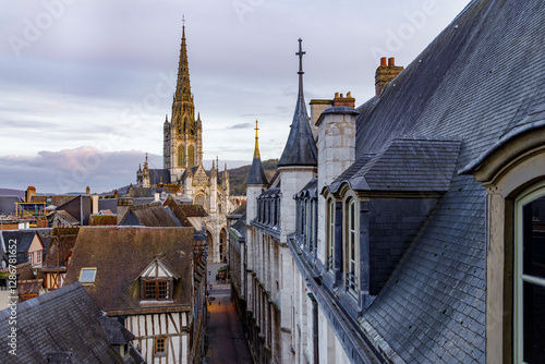 Fototapeta Naklejka Na Ścianę i Meble -  ROUEN, NORMANDY, FRANCE - 2025: elevated view on paved pedestrian Saint Romain street and Saint Maclou church, and roofs of half timbered medieval houses, historic center