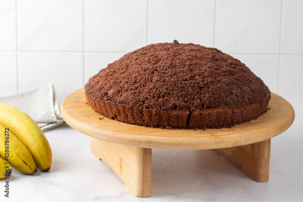 Homemade german mole cake with bananas, or maulwurfkuchen. Chocolate cake coat with crumbs, whipped cream. Turkish name; kostebek pasta