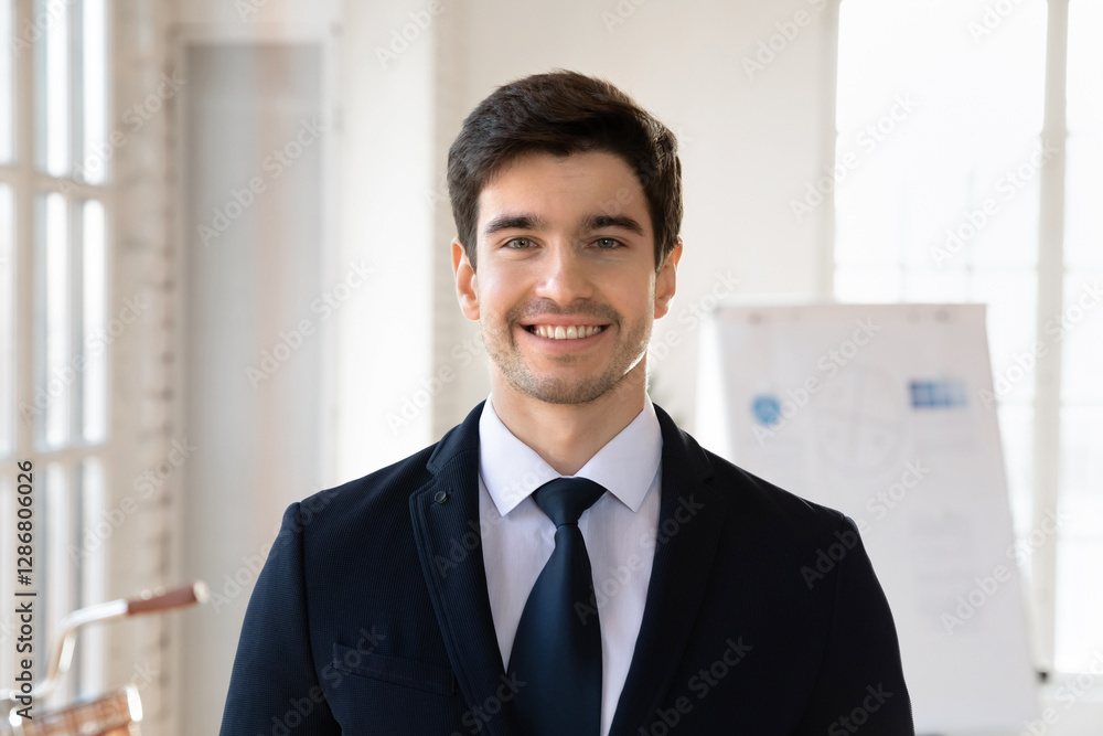 Head shot corporate staff member dressed in jacket and tie looks at camera, having handsome appearance, feels self-assured, satisfied with project completion, perspectives and business opportunities Head shot corporate staff member dressed in jacket and tie looks at camera, having handsome appearance, feels self-assured, satisfied with project completion, perspectives and business opportunities