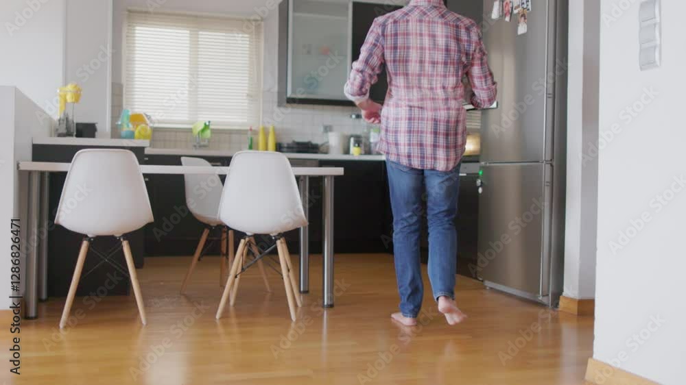 A father prepares a meal in the kitchen while his children play nearby in this beautifully captured slow-motion video. A father prepares a meal in the kitchen while his children play nearby in this beautifully captured slow-motion video.