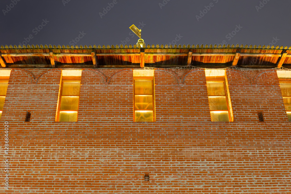 Fototapeta premium A brick building with a gold statue on top. Sights of the Nizhny Novgorod Kremlin