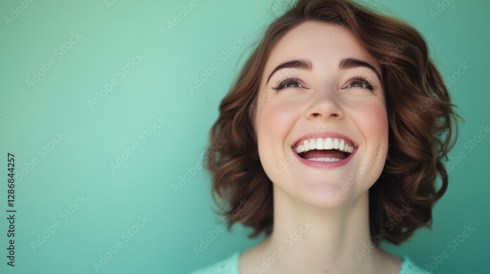 Joyful Caucasian Woman in Her Early 30s with a Wide Grin and Sparkling Eyes Against a Solid Mint Green Background Joyful Caucasian Woman in Her Early 30s with a Wide Grin and Sparkling Eyes Against a Solid Mint Green Background