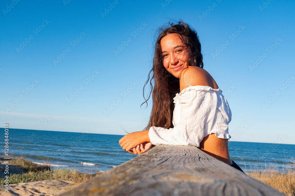 Beautiful young girl by the sea