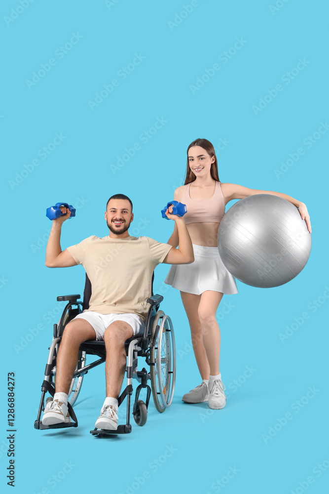 Obraz premium Young sporty man in wheelchair and with his wife on blue background