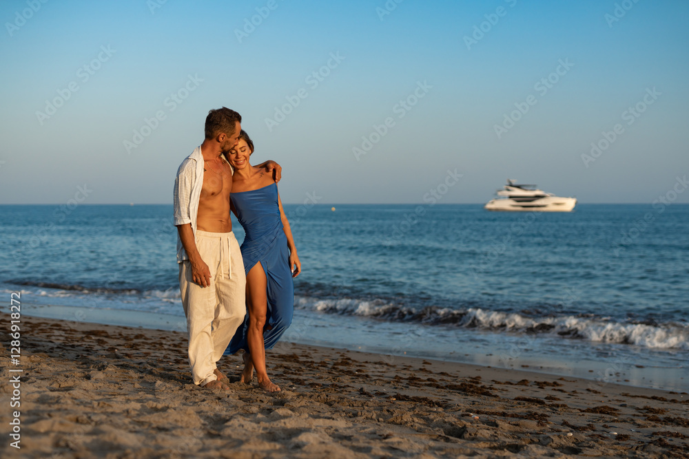 Romantic Couple Walking Along the Seashore at Sunset Romantic Couple Walking Along the Seashore at Sunset