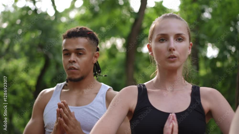 Two athletes run vigorously outdoors in a lush green setting, showcasing their fitness and determination Two athletes run vigorously outdoors in a lush green setting, showcasing their fitness and determination