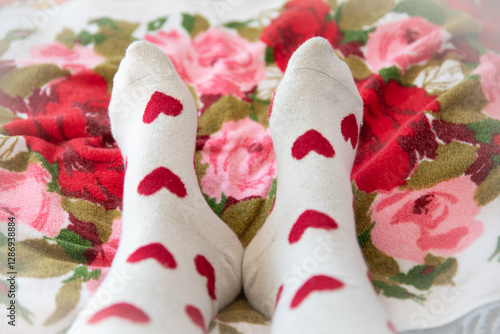 feet wearing socks with red hearts
