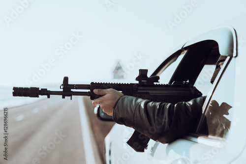 Fototapeta Criminal Using Weapon to Rob Civilians