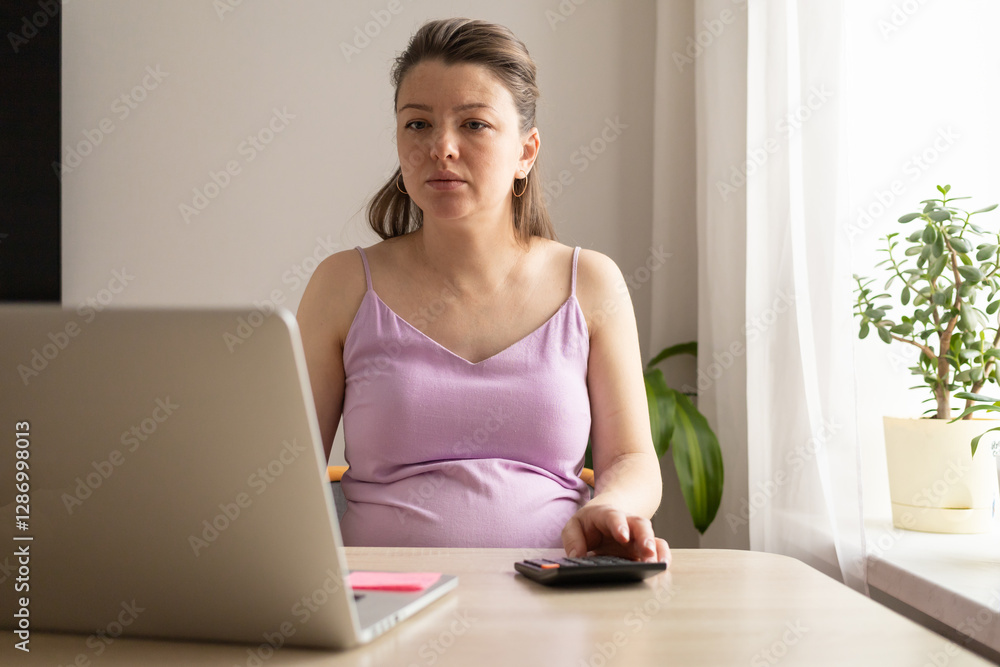 pregnant woman with calculator, computer pays utility bill. Receiving maternity benefits, social payments, maternity capital, donation. pregnancy and childbirth concept. calculate child's birth date pregnant woman with calculator, computer pays utility bill. Receiving maternity benefits, social payments, maternity capital, donation. pregnancy and childbirth concept. calculate child's birth date