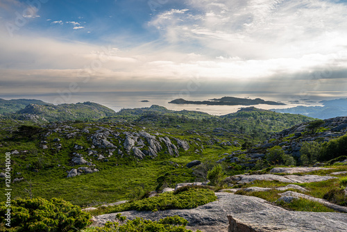 Photography rocky coastal landscape with distant islands and dramatic sky.