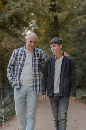 Father and son walking in the field, talking