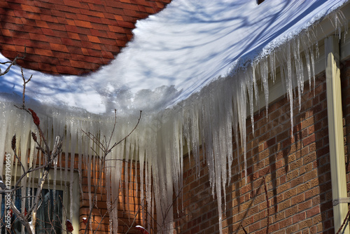 Ice dams in roof gutters from melting snow can cause water damage inside home, insufficient attic insulation is usually the cause.