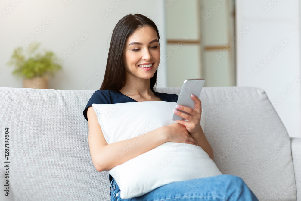 Happy Girl Using Mobile Phone Application, Texting And Browsing Internet Sitting On Couch At Home. Free Space Happy Girl Using Mobile Phone Application, Texting And Browsing Internet Sitting On Couch At Home. Free Space