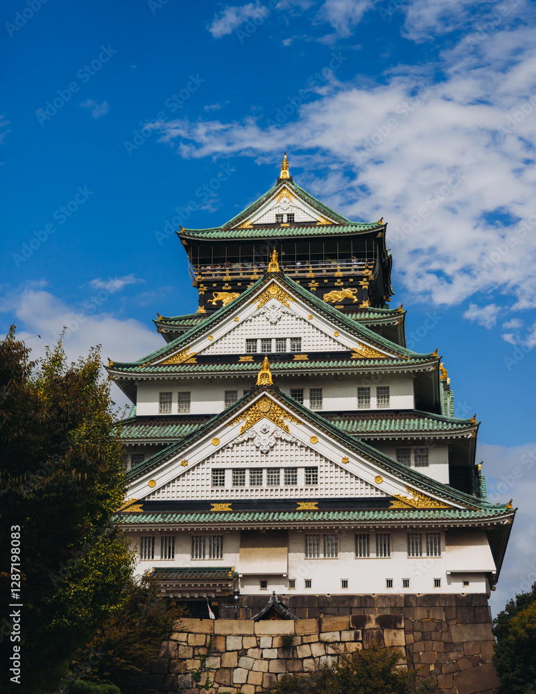 Fototapeta premium Osaka Castle, Osaka city, Japan, summer landscape vibrant view with a blue sky, Osakajo castle building, Kansai region, Osaka prefecture, travel to Japan