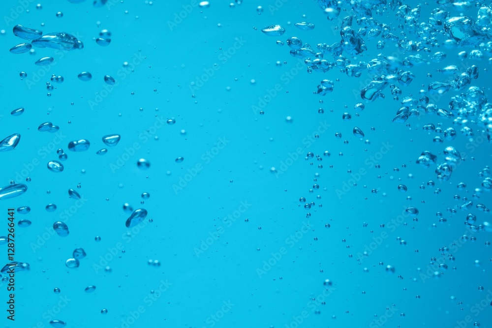 Many water bubbles on blue background, closeup Many water bubbles on blue background, closeup
