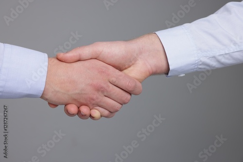 Wallpaper Mural Businessmen shaking hands on grey background, closeup Torontodigital.ca