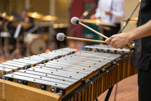 Musician playing vibraphone with mallets in performance setting