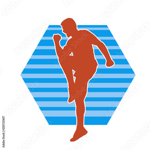 Silhouette of a sporty male in action pose at the gym. Silhouette of a slim man in aerobics workout pose.