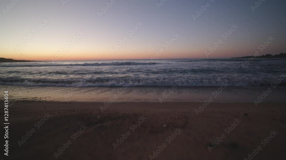 Golden light spreads across the sky and sea as the sun sets over a quiet beach. Gentle waves and drifting clouds enhance the serene mood. Cinematic 4K. Golden light spreads across the sky and sea as the sun sets over a quiet beach. Gentle waves and drifting clouds enhance the serene mood. Cinematic 4K.