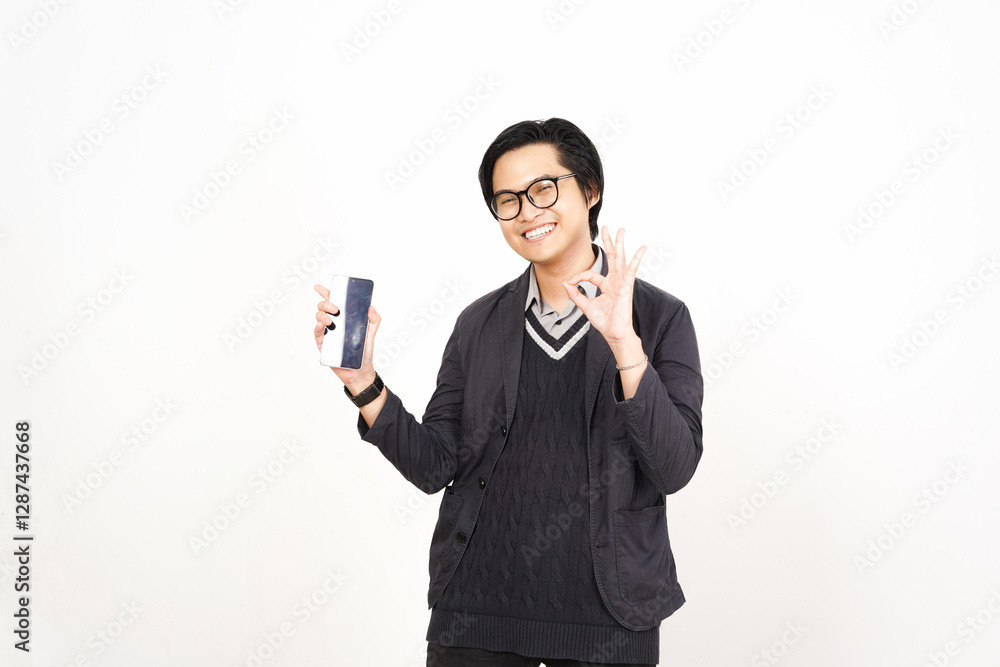 Smiling face showing okay sign Holding Smartphone and Presenting blank screen for copy space Of Handsome Asian Man Isolated On White Background Smiling face showing okay sign Holding Smartphone and Presenting blank screen for copy space Of Handsome Asian Man Isolated On White Background