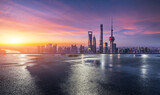 Shanghai skyline at sunrise with reflection on wet ground
