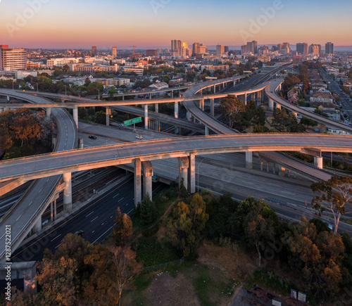 Aerial view of a freeway overpass Oakland at sunrise. Traffic flows smoothly, showcasing urban sprawl and infrastructure. Longfellow, Oakland, California, USA