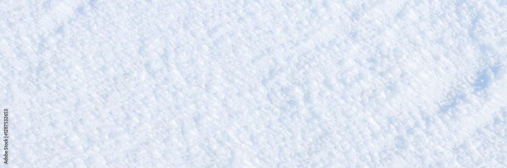 Obraz premium Natural snow texture. The surface of an icy snow crust. Snowy ground. Winter background with snow patterns. Perfect for Christmas and New Year design. Closeup top view.
