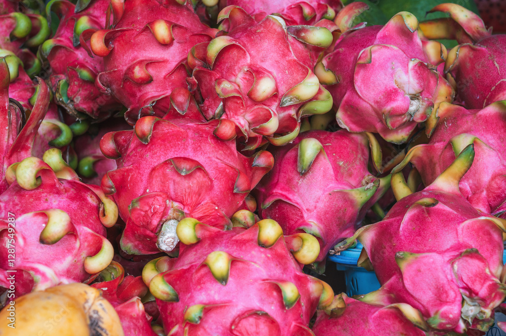Harvest of ripe red dragon fruits pitahaya on counter at an Asian street market in Thailand close-up Harvest of ripe red dragon fruits pitahaya on counter at an Asian street market in Thailand close-up