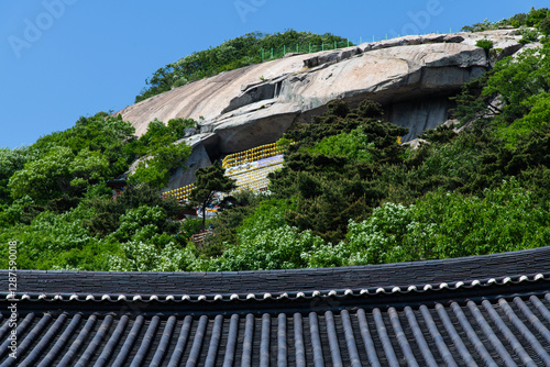 tiled roof and cliff in the Buddhist temple  photo