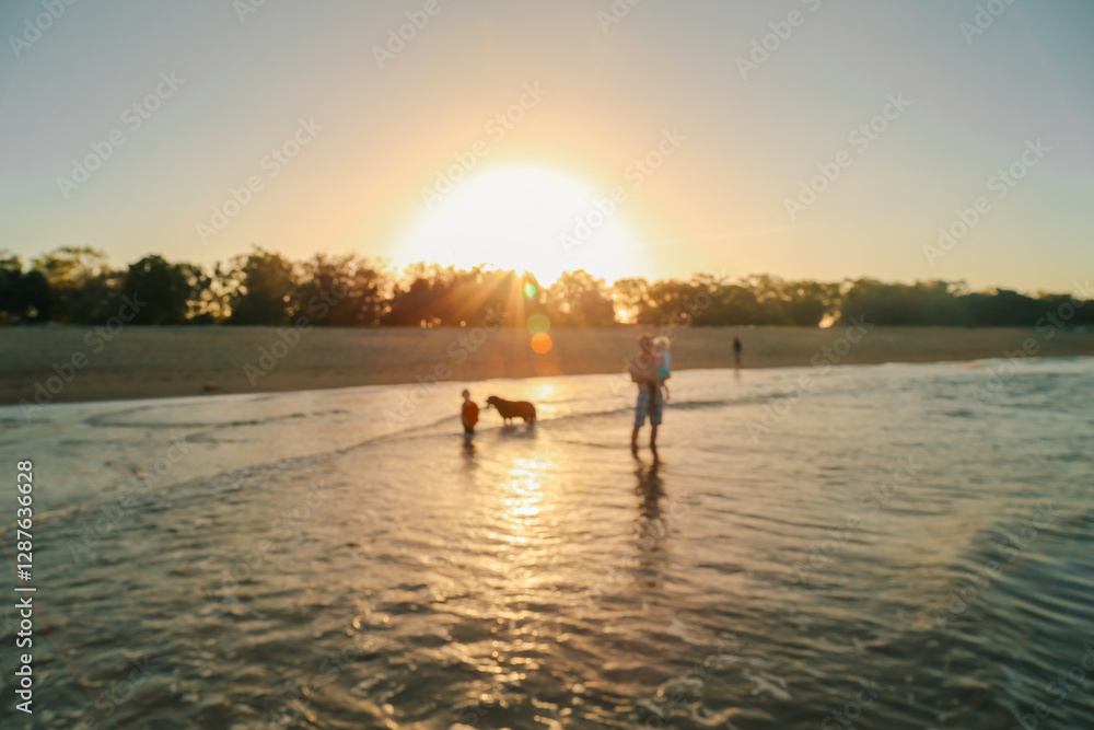 Soft focus shot of family time at the beach in North Queensland in golden afternoon light Soft focus shot of family time at the beach in North Queensland in golden afternoon light