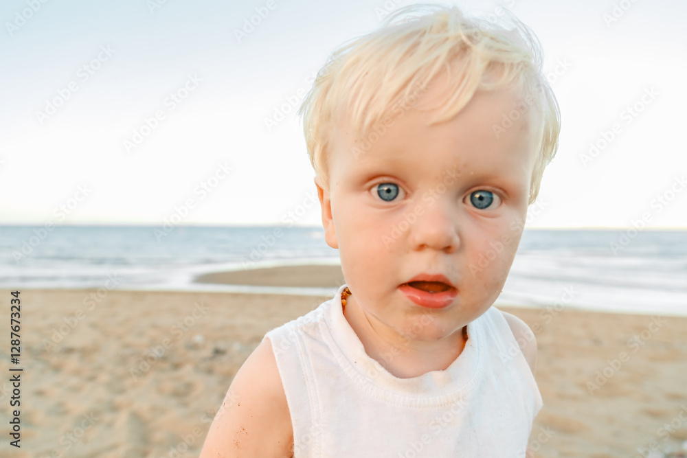 Close up portrait of little boy with blue eyes at the beach Close up portrait of little boy with blue eyes at the beach