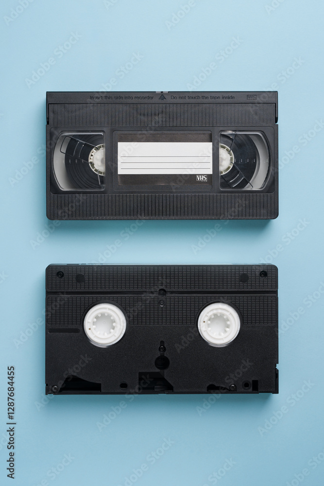 Obraz premium Top view of old VHS video tape on blue background