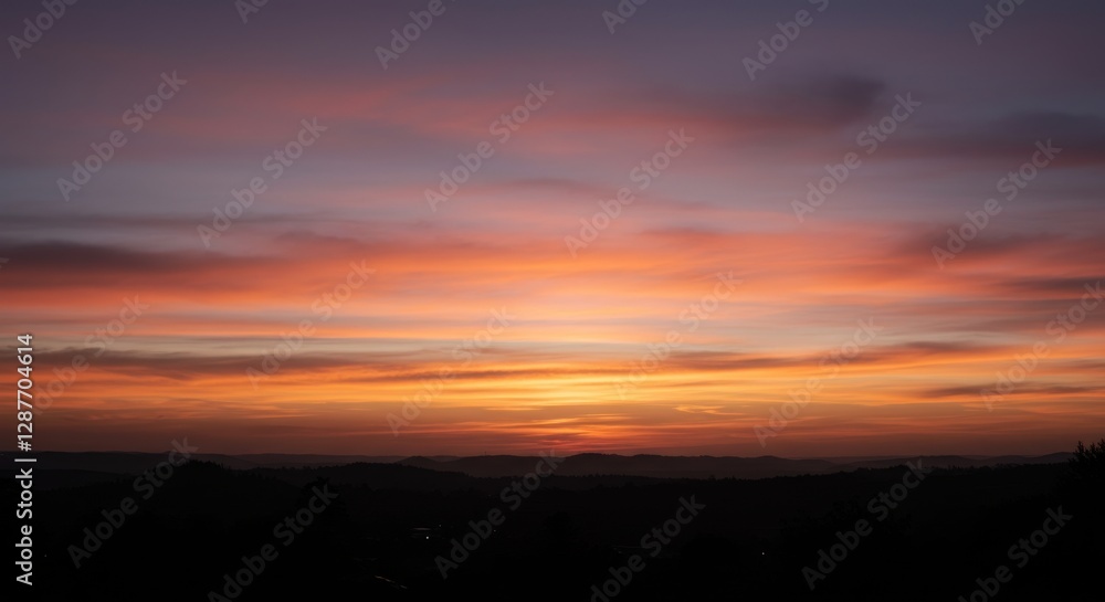Serene sunset over rolling hills with vibrant colors and distant mountains Serene sunset over rolling hills with vibrant colors and distant mountains
