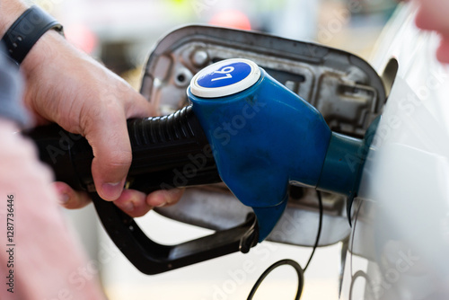 Service station fuel pump detail of nozzles for unleaded 91 petrol filling up car