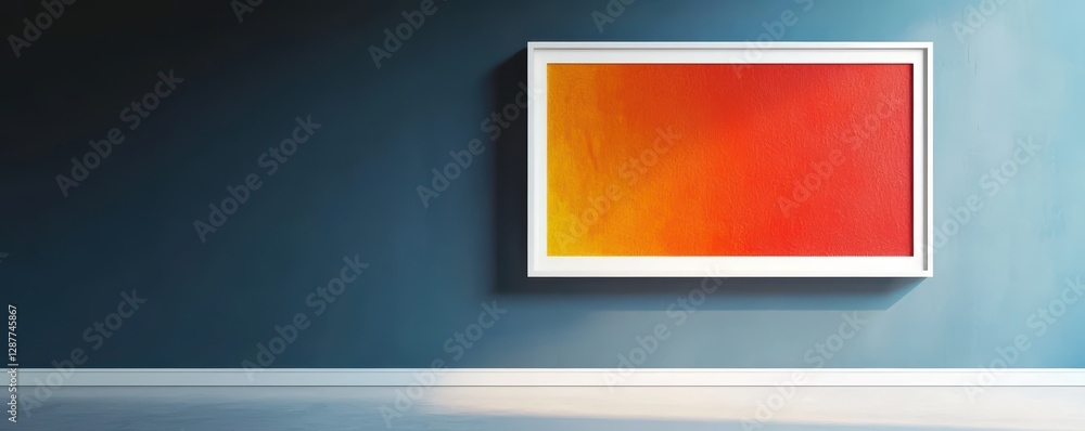 Fototapeta premium A vibrant abstract painting in a white frame hangs on a dark blue wall, creating a striking contrast and modern aesthetic.