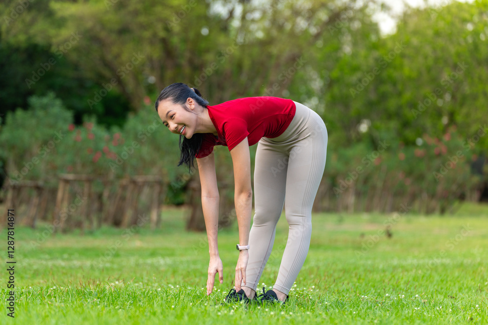 Young Asian Woman Doing Stretching Exercise Relaxingly Outdoors in a Park Young Asian Woman Doing Stretching Exercise Relaxingly Outdoors in a Park