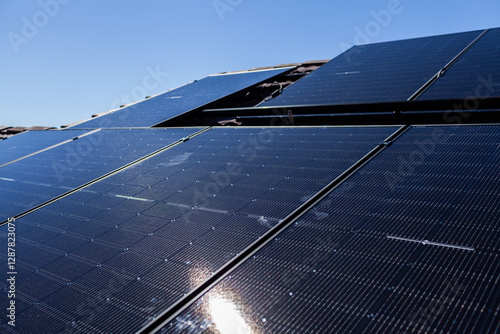 All Black bifacial solar panels on roof being installed and connected to power system photo