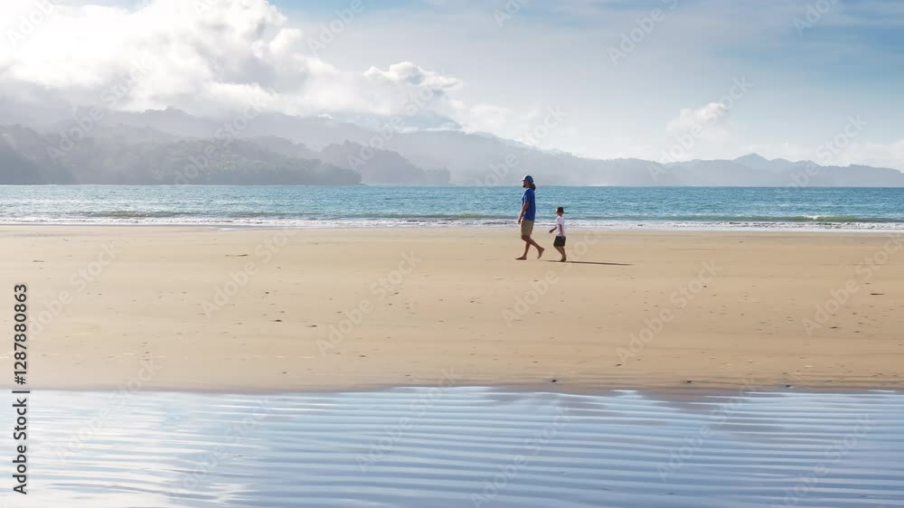 A heartfelt moment of a father and son walking hand in hand on Punta Uvita beach, creating memories in Marino Ballena National Park, Costa Rica A heartfelt moment of a father and son walking hand in hand on Punta Uvita beach, creating memories in Marino Ballena National Park, Costa Rica