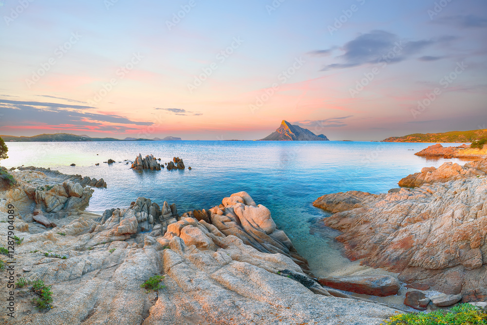Superb evening scene of Porto Taverna beach with Tavolara mountain on background.